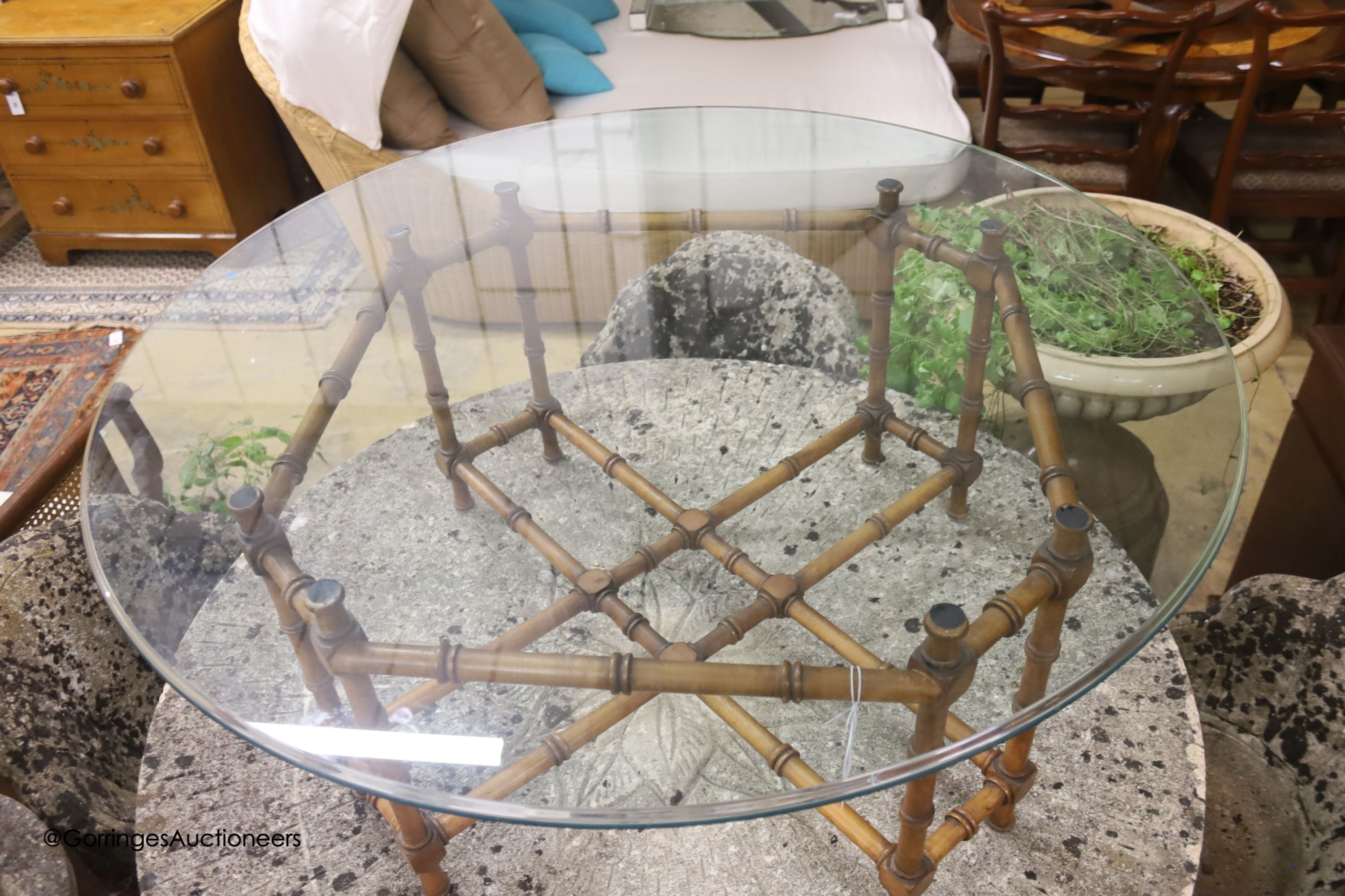 A circular faux bamboo framed glass topped coffee table, diameter 101cm, height 42cm